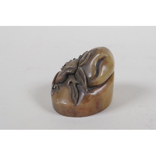 64 - A Chinese carved soapstone seal with peach decoration, 4.5cm high