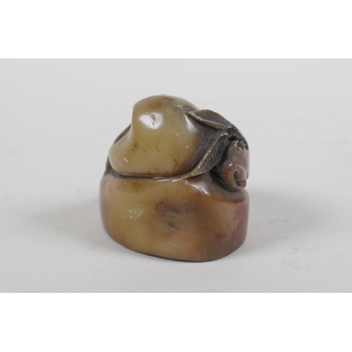 64 - A Chinese carved soapstone seal with peach decoration, 4.5cm high