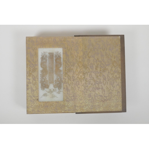 86 - A Chinese wood and silk bound book containing white jade table pages with chased and gilt inscriptio... 