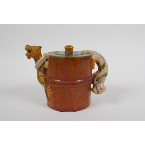 87 - A Chinese sancai crackle glazed pottery teapot with kylin handle and spout, 11cm high