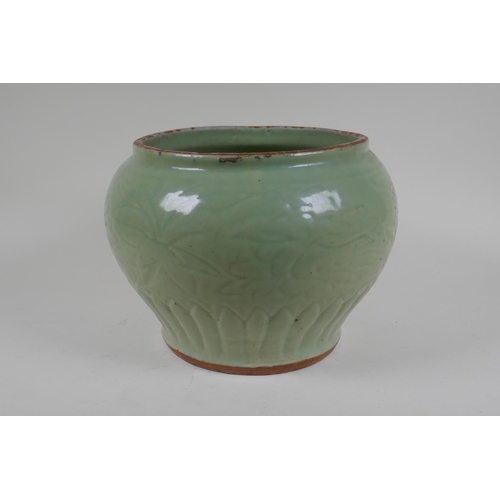 9 - A Chinese Ming period (1369-1644) celadon glazed porcelain jar with incised lotus flower decoration,... 