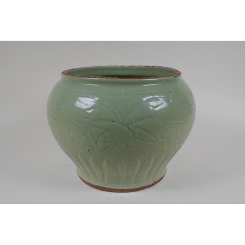 9 - A Chinese Ming period (1369-1644) celadon glazed porcelain jar with incised lotus flower decoration,... 