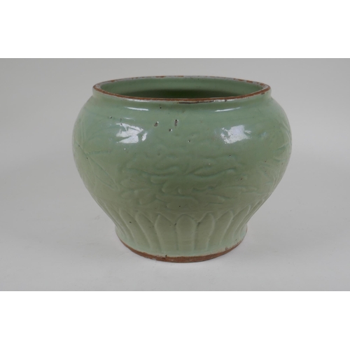 9 - A Chinese Ming period (1369-1644) celadon glazed porcelain jar with incised lotus flower decoration,... 