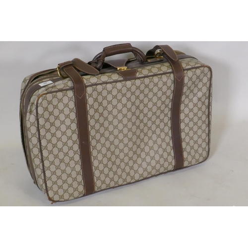 90 - A Gucci suitcase with leather straps, and padlock in wallet, 62 x 40 x 20cm