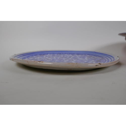 98 - An antique Continental tin glazed blue and white dish with floral decoration, together with a Contin... 