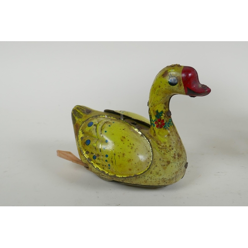 99 - A vintage Chinese Gosling Goose clockwork tin toy, and a later German tin plate Merry-Go-Round, larg... 