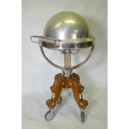 611 - A silver plated revolving meat carving trolley with roll top cover raised on a wood base with castor... 