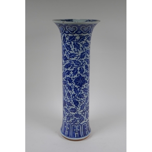 14 - A C19th Chinese blue and white porcelain cylinder vase with allover scrolling floral decoration, 46c... 