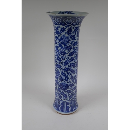 14 - A C19th Chinese blue and white porcelain cylinder vase with allover scrolling floral decoration, 46c... 