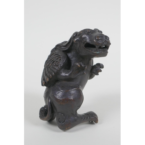 40 - A Chinese bronze figure of a winged mythical beast, 10cm high