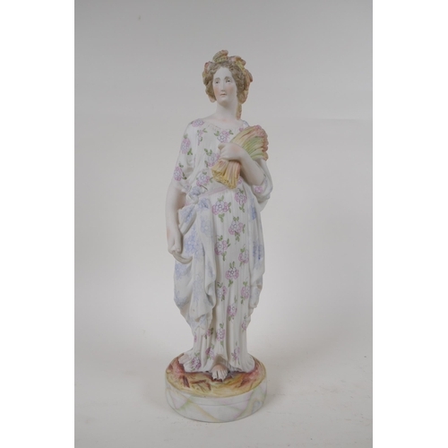 52 - An antique Bisque figure of a lady gathering wheat, in hand painted floral clothing, together with a... 