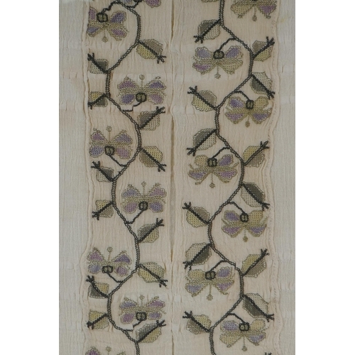 65 - A C19th embroidery of a floral vine, with gilt thread details, framed, 26 x 42cm