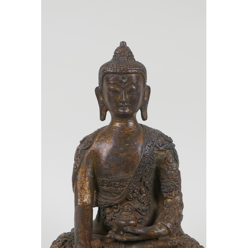 66 - A Tibetan gilt bronze figure of Buddha seated in meditation, impressed double vajra mark to base, 22... 