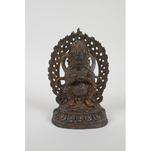 67 - A Tibetan gilt bronze figure of a wrathful deity, impressed double vajra mark to base, 17cm high