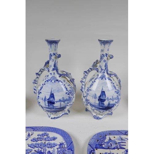 69 - A pair of Delft Royal Bonn porcelain vases with two handles, together with two Delft slender necked ... 