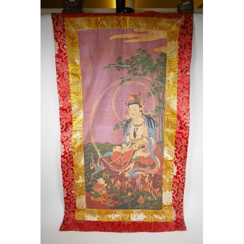 75 - A Sino Tibetan printed tangka with gold and red silk surround, 60 x 110cm