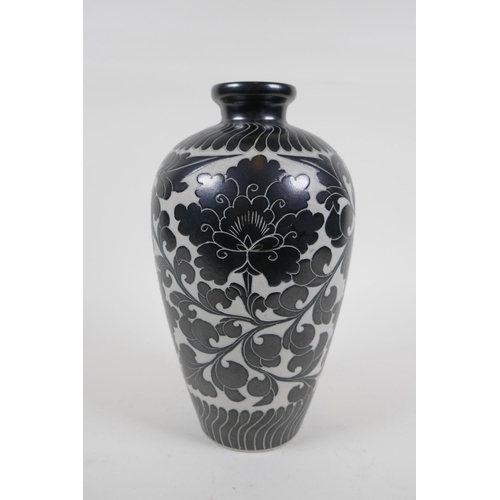 78 - A late C19th/early C20th Chinese Cizhou kiln vase with chased lotus flower decoration, 26cm high