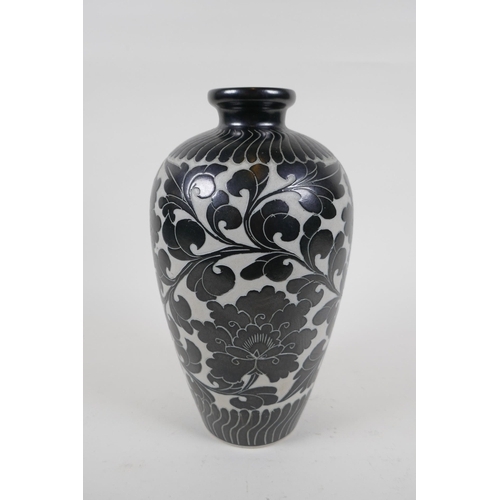 78 - A late C19th/early C20th Chinese Cizhou kiln vase with chased lotus flower decoration, 26cm high