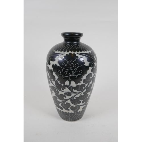 78 - A late C19th/early C20th Chinese Cizhou kiln vase with chased lotus flower decoration, 26cm high