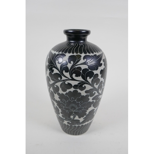 78 - A late C19th/early C20th Chinese Cizhou kiln vase with chased lotus flower decoration, 26cm high