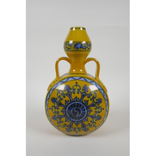 80 - A Chinese yellow ground porcelain moon flask with garlic head shaped neck, two handles and blue and ... 