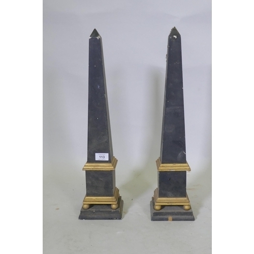 113 - A pair of painted wood and parcel gilt obelisks, 55cm high