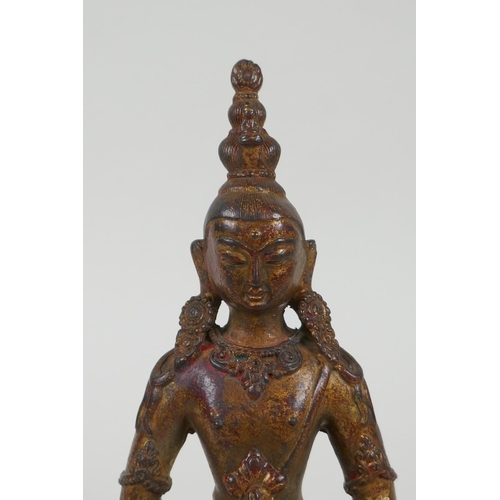 131 - A Tibetan gilt bronze figure of Buddha holding a stupa, 20cm long