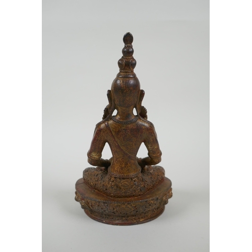 131 - A Tibetan gilt bronze figure of Buddha holding a stupa, 20cm long