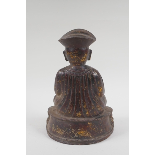 142 - A Chinese bronze figure of a priest seated in meditation, with the remnants of gilt patina, 24cm hig... 