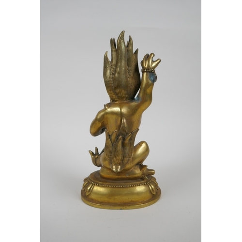 144 - A Tibetan bronze of a wrathful beast seated on a pig, double vajra mark to base, 22cm high