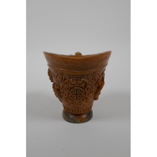 163 - A Chinese faux horn libation cup decorated with kylin and auspicious symbols, seal mark to base, 10c... 