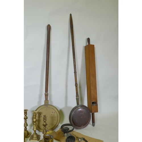 178 - A quantity of copper and brass, footman skillets, candlesticks, bed warmers, set of postage scales w... 