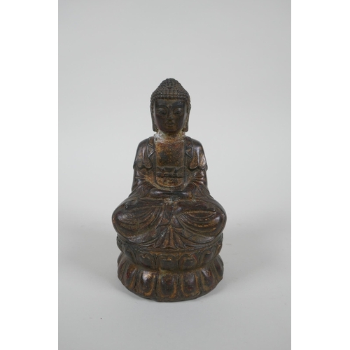 186 - A Chinese filled gilt bronze figure of Buddha, 4 character mark to base, 14cm high