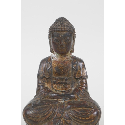 186 - A Chinese filled gilt bronze figure of Buddha, 4 character mark to base, 14cm high