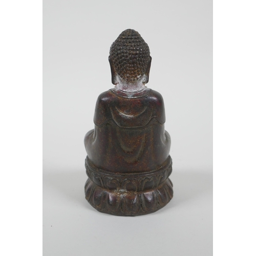 186 - A Chinese filled gilt bronze figure of Buddha, 4 character mark to base, 14cm high