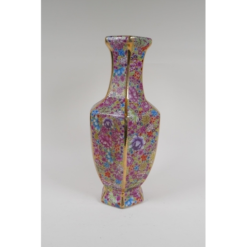 188 - A Chinese polychrome porcelain vase of hexagonal form with allover foliate decoration, 4 character m... 