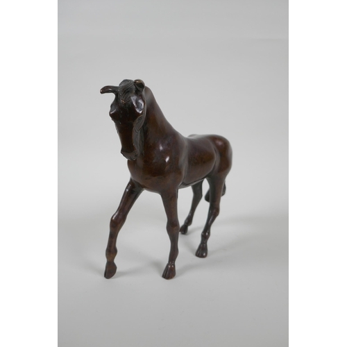 193 - A filled bronze horse, 20cm high