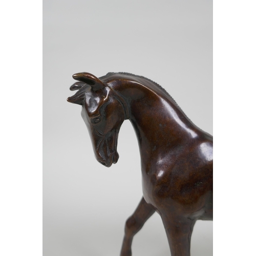 193 - A filled bronze horse, 20cm high