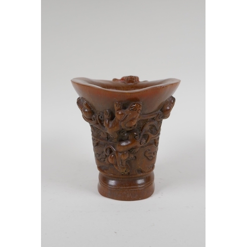 197 - A Chinese faux horn libation cup decorated with climbing kylin, impressed seal mark to base, 14cm hi... 