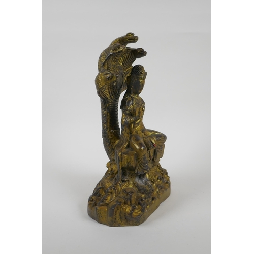 201 - A Sino Tibetan gilt bronzed metal Buddha seated on a cobra throne, impressed Yongle 6 character mark... 