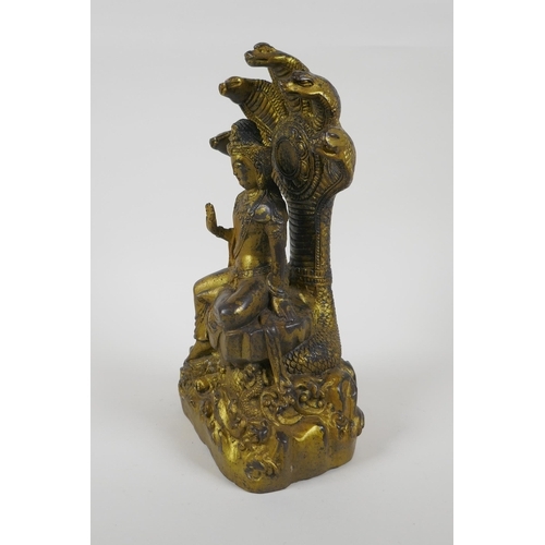 201 - A Sino Tibetan gilt bronzed metal Buddha seated on a cobra throne, impressed Yongle 6 character mark... 