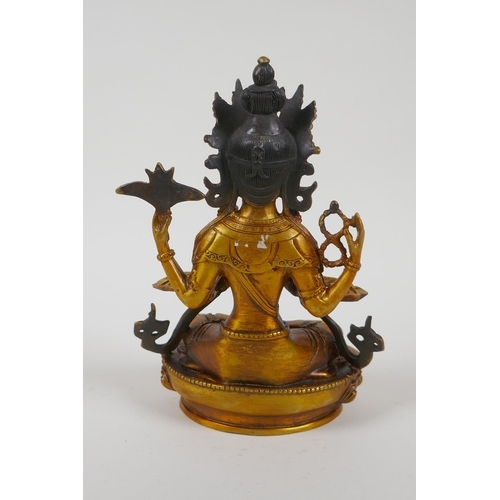 207 - A Tibetan gilt bronze figure of a female deity, double vajra mark to base, 21cm high