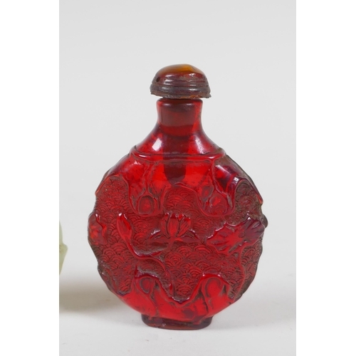 208 - A Chinese carved hardstone roundel in the form of a deer, and a faux amber snuff bottle, 7cm high