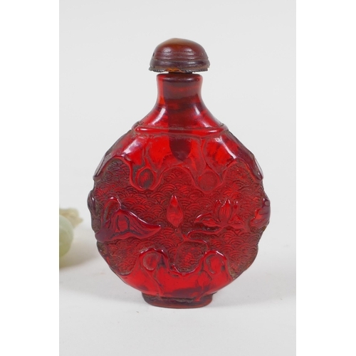 208 - A Chinese carved hardstone roundel in the form of a deer, and a faux amber snuff bottle, 7cm high