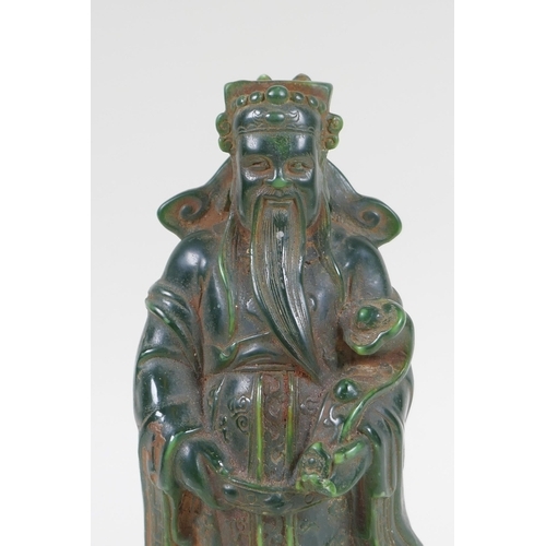 210 - A Chinese moulded green glass figure of an immortal, 20cm high