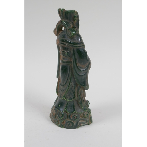 210 - A Chinese moulded green glass figure of an immortal, 20cm high