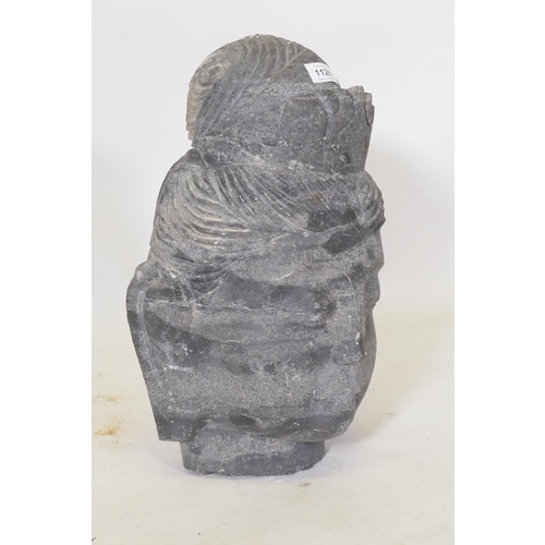 1126 - A carved schist stone Buddha's head, 42cm high