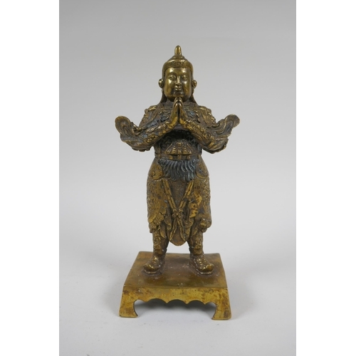 217 - A Chinese gilt bronze figure of an immortal in armour, 4 character mark verso, 23cm high