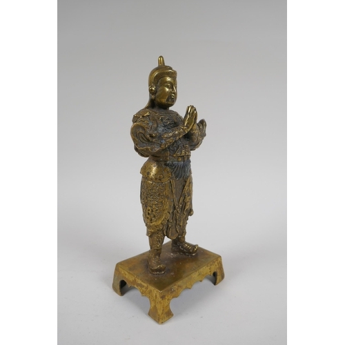 217 - A Chinese gilt bronze figure of an immortal in armour, 4 character mark verso, 23cm high