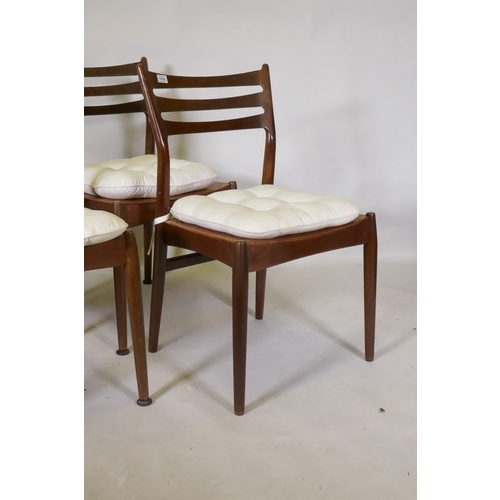 1118 - A set of four mid century mahogany dining chairs with squab cushions